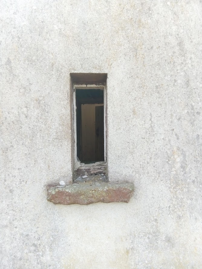 a narrow window with no window-pane.