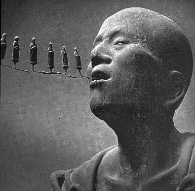 (detail from the head of a) Statue of (itinerant Buddhist ascetic) Kūya by Kōshō, son of Unkei, at Rokuharamitsu-ji (六波羅蜜寺), Kyoto, dating to the first decade of the thirteenth century and an Important Cultural Property. The six Chinese characters of the nembutsu, 南無阿弥陀仏 (na-mu-a-mi-da-butsu), are represented by six small figures of Amitābha streaming from Kūya's mouth. He walks as if on a pilgrimage, holding a staff topped with an antler and striking a gong. (w/ thanks to wikipedia.org for the image description.)